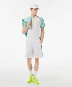 Lacoste Tennis>Herren Tennis Poloshirt Aus Recyceltem Polyester Mit Ultra-Dry-Technologie Weis / Hellgrun / Gelb Awc